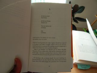 Myself holding up the opening of the first page of Octavia Bulter's The Parable of the Sower